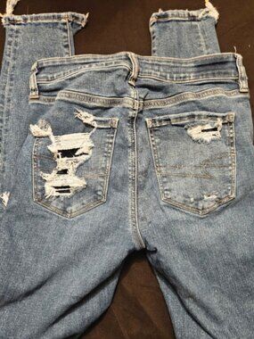 Distressed Blue Denim Jeans with Frayed Hems